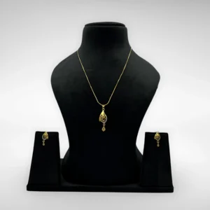 Gold-plated leaf pendant necklace set with matching drop earrings on white background