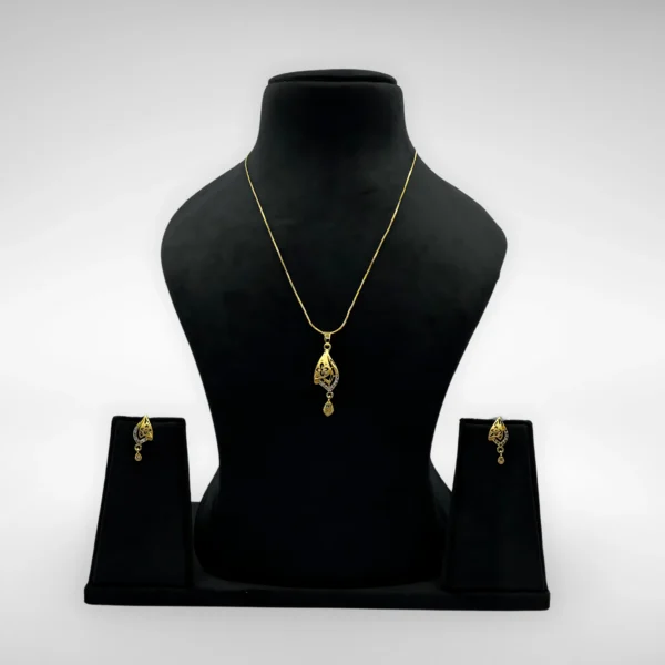 Gold-plated leaf pendant necklace set with matching drop earrings on white background