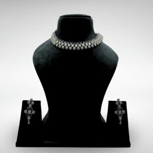 Elegant silver floral choker necklace set with detachable earrings displayed on a black velvet stand against a light grey background