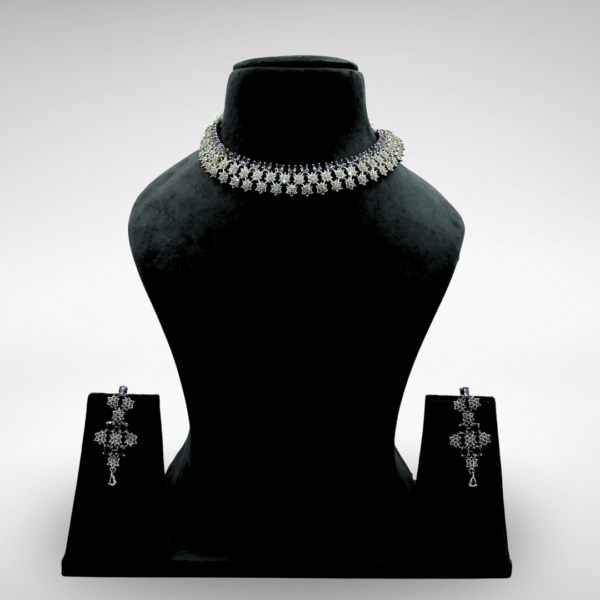 Elegant silver floral choker necklace set with detachable earrings displayed on a black velvet stand against a light grey background