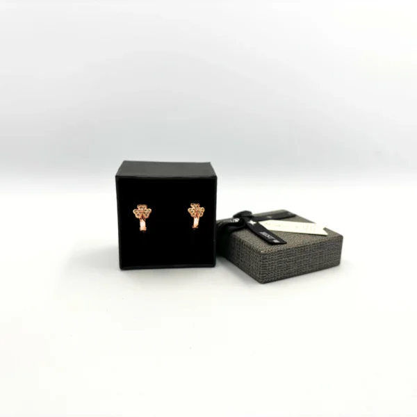 Rose gold floral stud earrings with green stone detailing