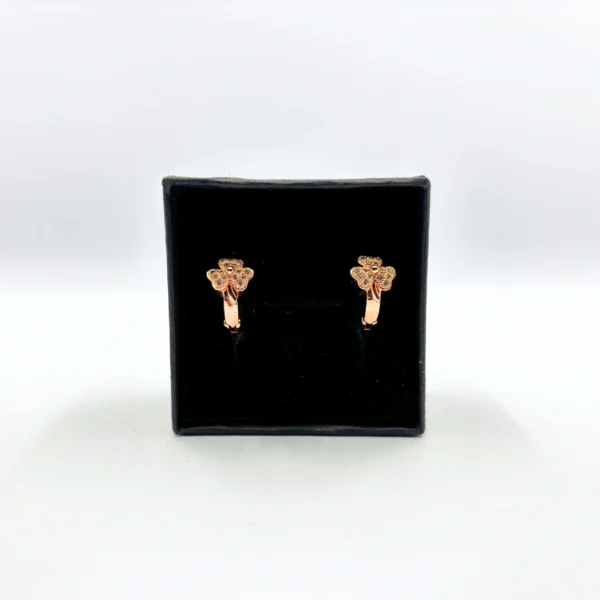 Rose gold floral stud earrings with green stone detailing
