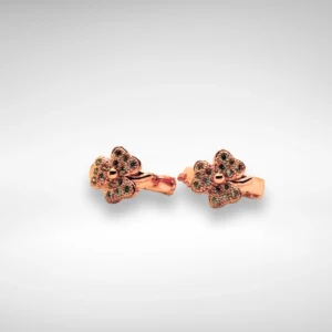 Rose gold floral stud earrings with green stone detailing