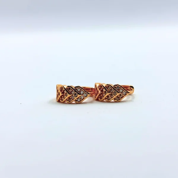 Gold-plated leaf pattern earrings with American diamond stones