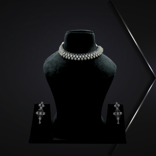 Elegant silver floral choker necklace set with detachable earrings displayed on a black velvet stand against a light grey background