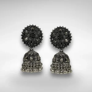 Oxidised silver jhumka earrings with floral top and dome base with hanging beads on a white background