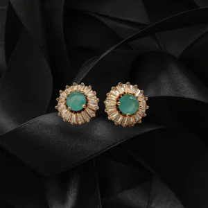 Elegant green stud earrings with baguette-cut crystals on black satin background
