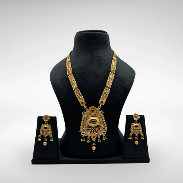 Antique matte gold South Indian temple necklace set with rectangular pendant and earrings on black bust stand against light grey background